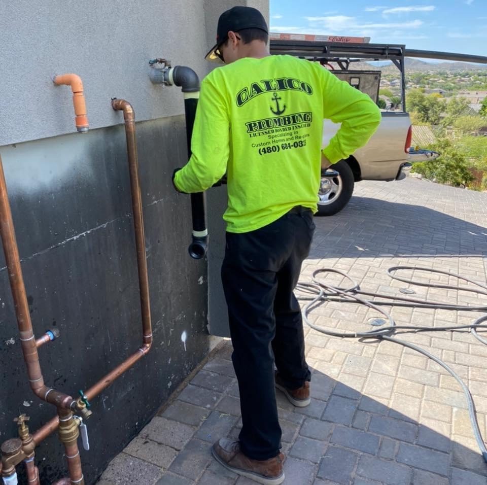Calico Plumbing technician working on exterior plumbing
